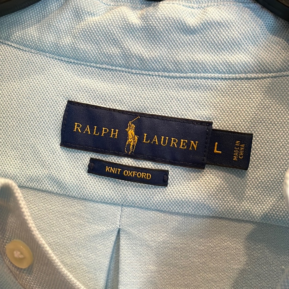 Light blue polo shirt with navy blue blue embroidered sailfish. Great condition